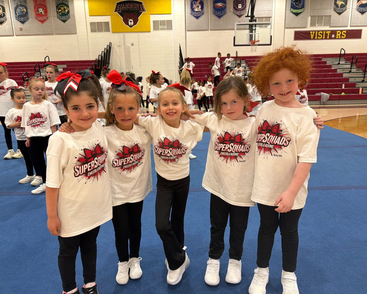 Five SuperSquads cheerleaders standing arm in arm in their team shirts